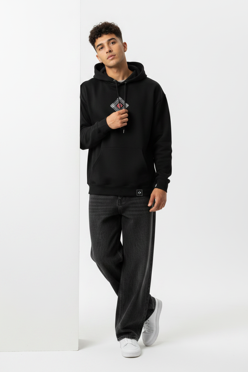 Black hoodie leaning wall casual pose