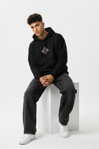 Black hoodie sitting forward on cube