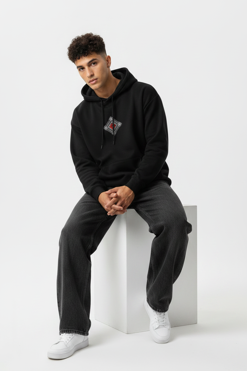 Black hoodie sitting forward on cube